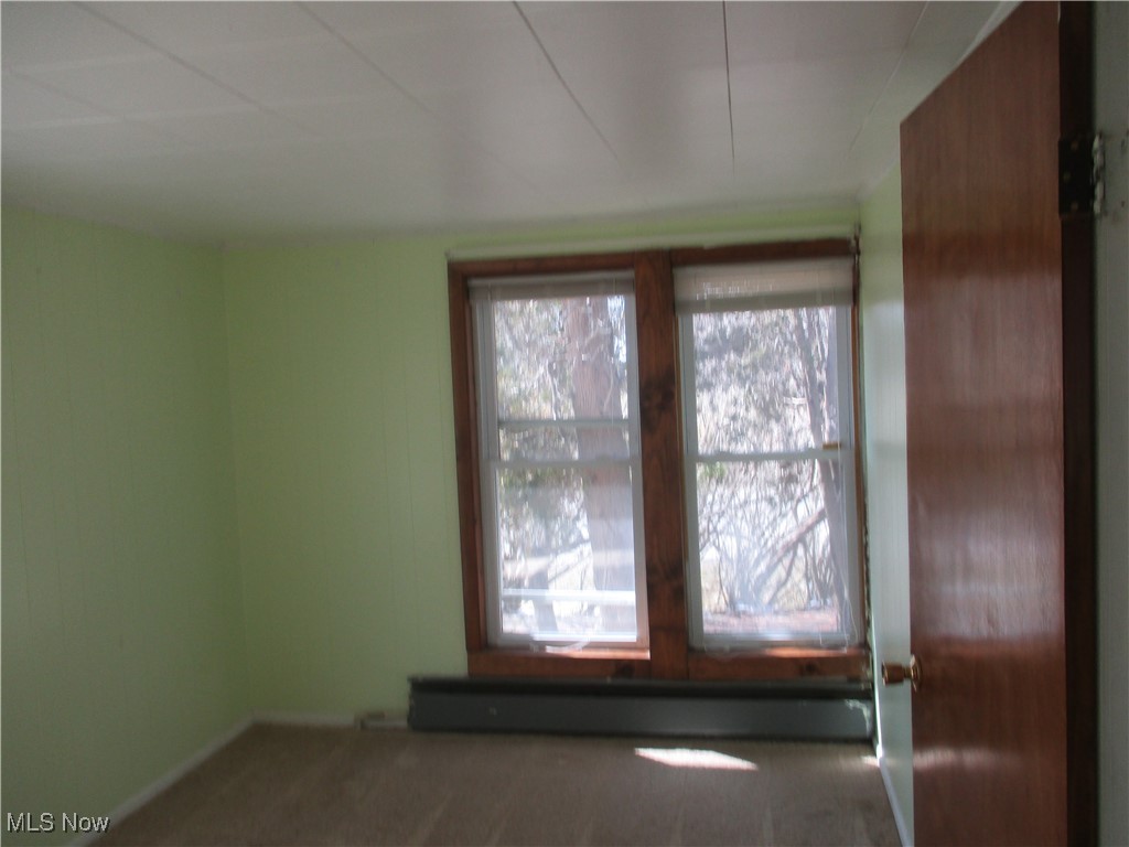 15401 A Madison Road Middlefield, OH 44062 - Photo 17 of 17 Carpeted bedroom with rod the width of room vs closet