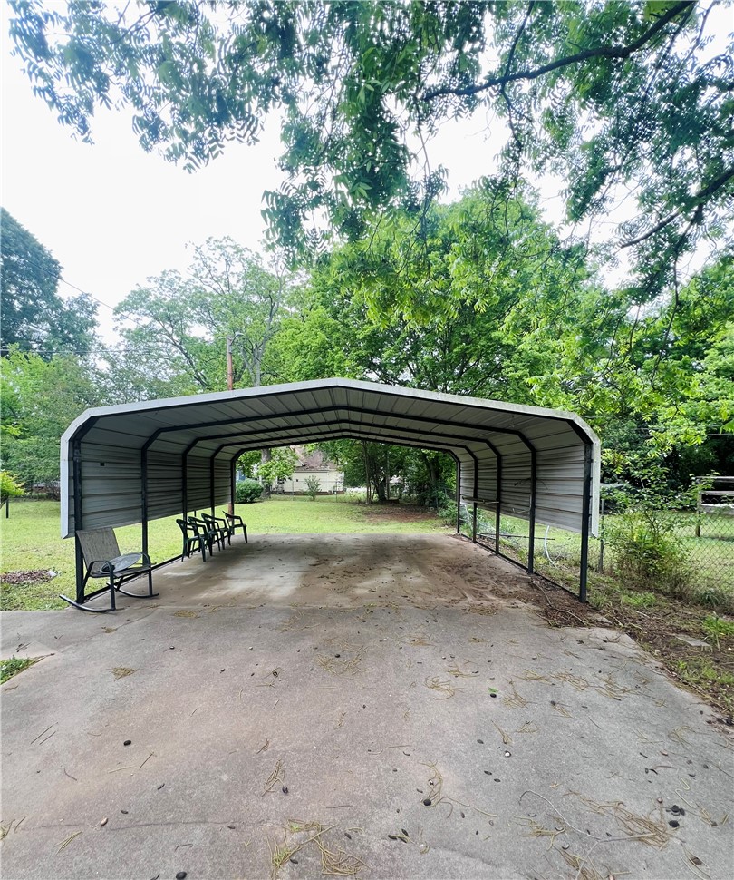 204 G Street Anderson, SC 29625 - Photo 7 of 8 A spacious carport offers convenient, sheltered parking for your vehicles.