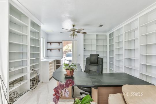 712 East Kendall Avenue Ridgecrest, CA 93555 - Photo 20 of 50 a view of a workspace with furniture and a potted plant