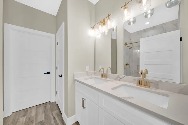 a bathroom with a sink double vanity and a mirror