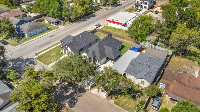 an aerial view of a house with a yard