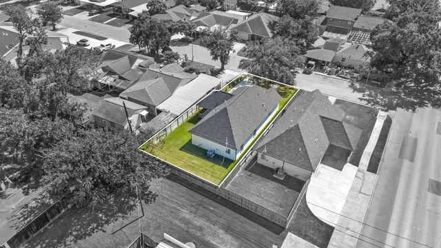 an aerial view of a house with a swimming pool