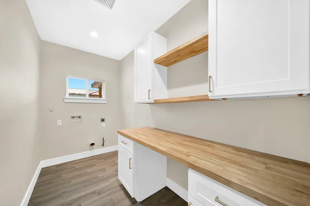 a room with a wooden floor and cabinets