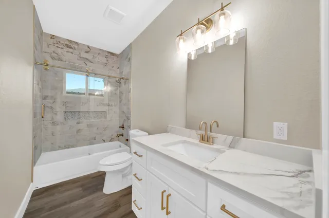 a bathroom with a sink a toilet and bathtub