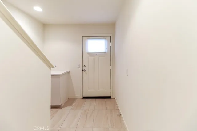 a view of a room with wooden floor and staircase