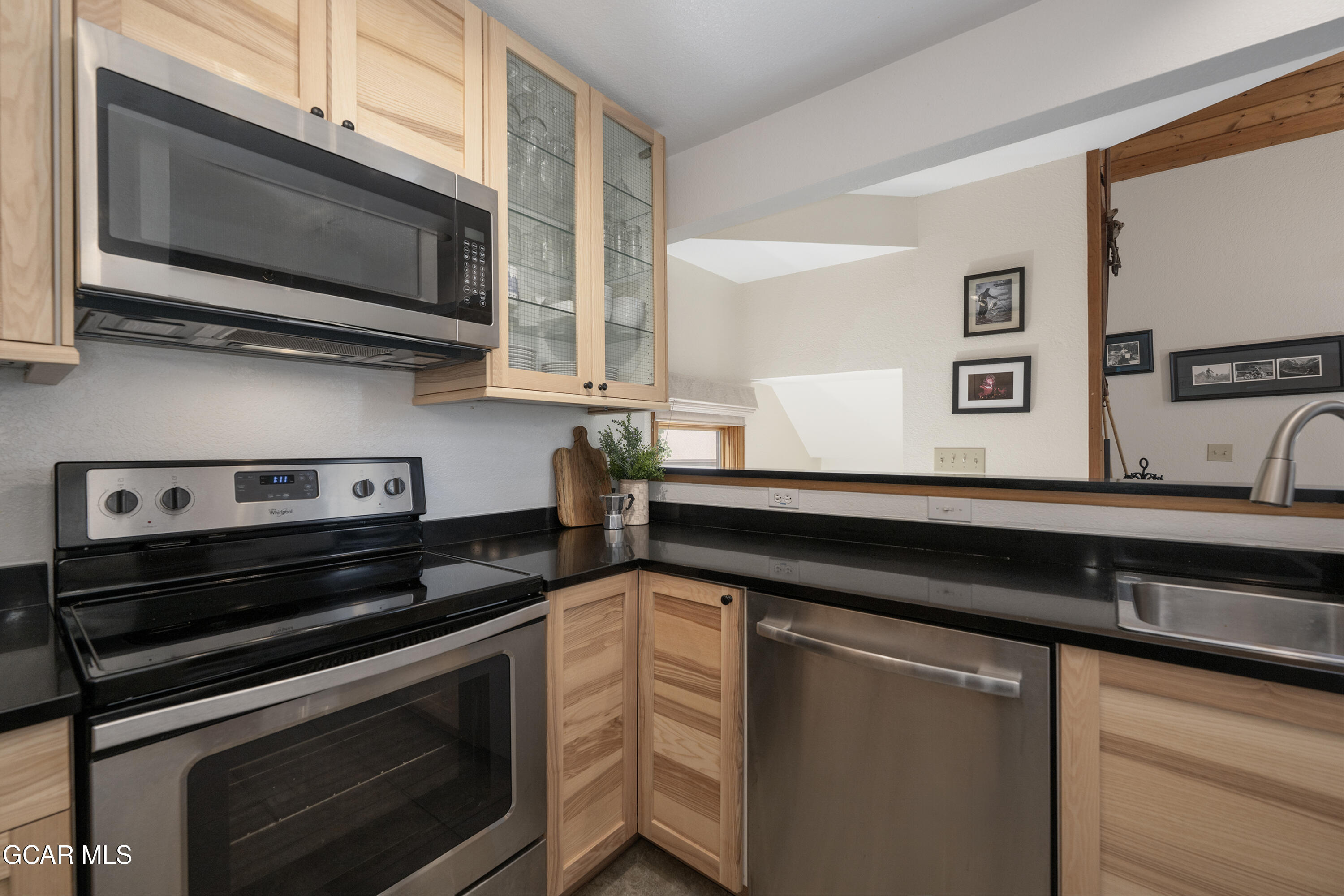 820 Wolverine Lane, Unit 3 Fraser, CO 80442 - Photo 13 of 43 a kitchen with a sink stove and microwave