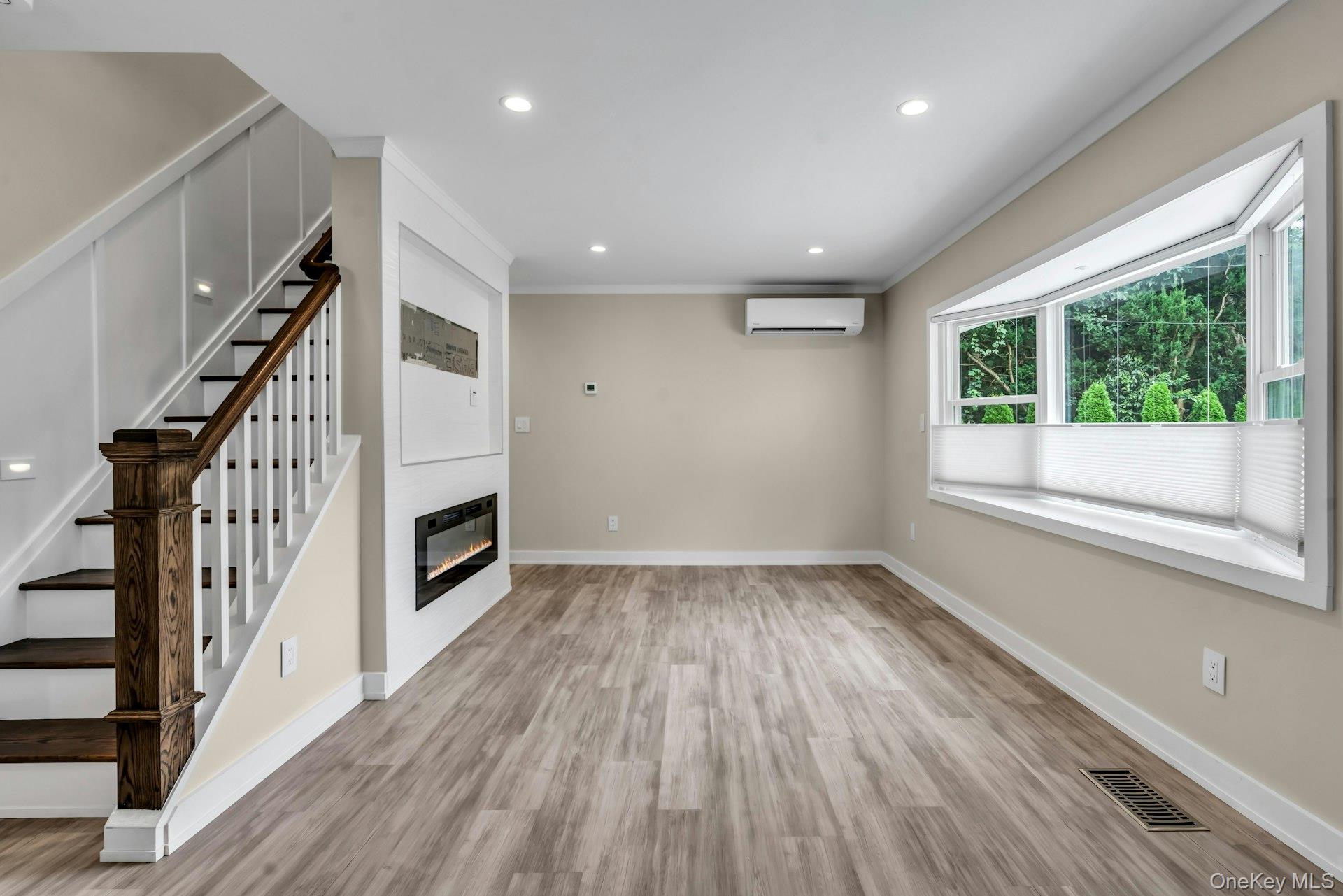 20 Robert Road Glen Cove, NY 11542 - Photo 3 of 23 Living room with fireplace, new recessed lighting and spacious bay window.