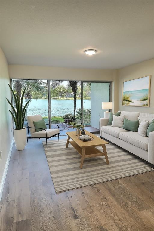 620 Orange Drive, Unit 225 Altamonte Springs, FL 32701 - Photo 3 of 25 a living room with furniture and large windows