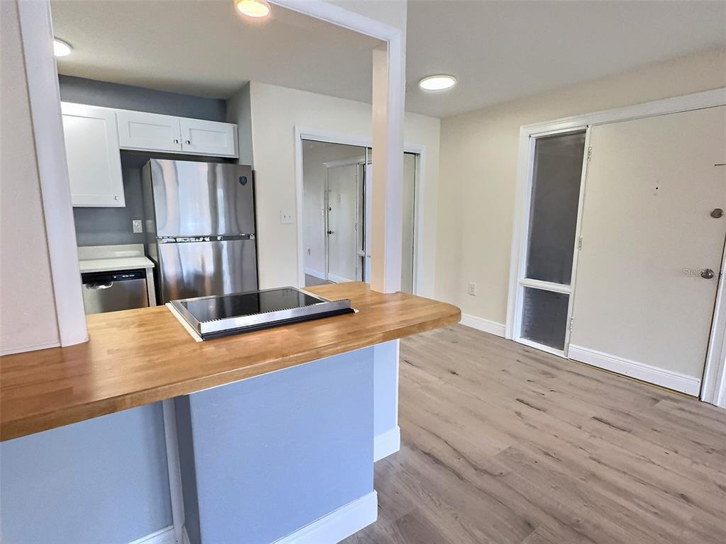 620 Orange Drive, Unit 225 Altamonte Springs, FL 32701 - Photo 7 of 25 a kitchen with kitchen island a counter top space a sink and refrigerator