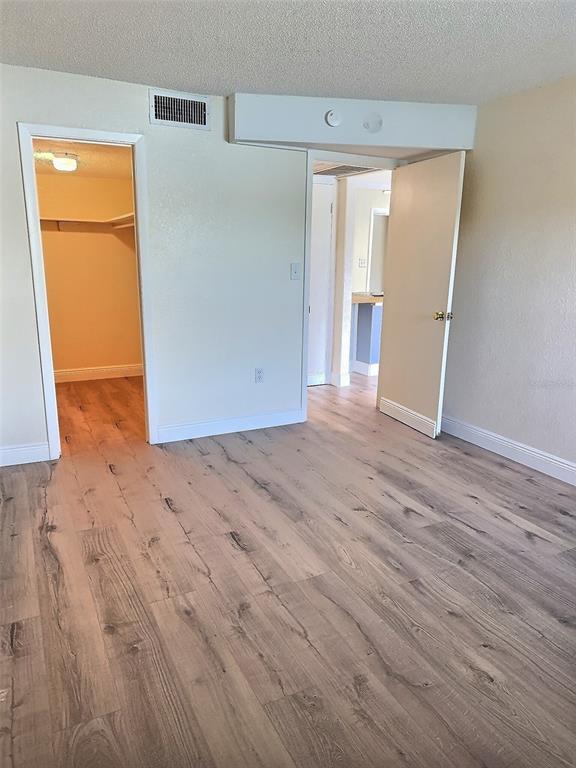 620 Orange Drive, Unit 225 Altamonte Springs, FL 32701 - Photo 9 of 25 an empty room with wooden floor and a window