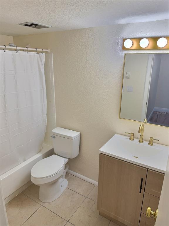 620 Orange Drive, Unit 225 Altamonte Springs, FL 32701 - Photo 10 of 25 a bathroom with a toilet a sink and a mirror