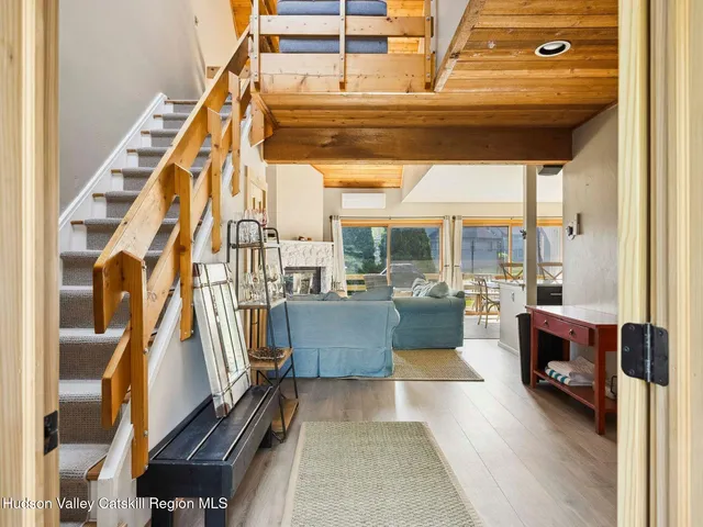 a view of living room with furniture and a floor to ceiling window