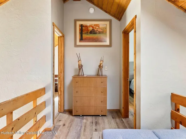 a view of a hallway with wooden floor and a closet