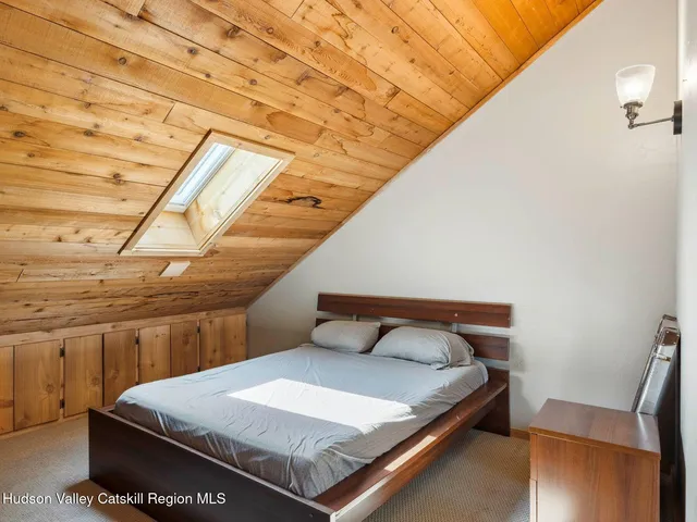 a bed sitting in a bedroom next to a window