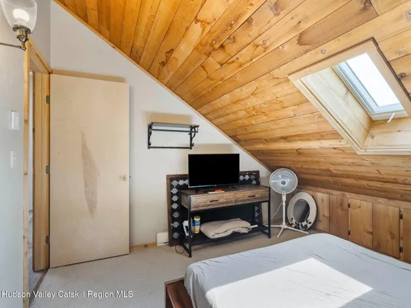 a room with furniture a flat screen tv and dresser