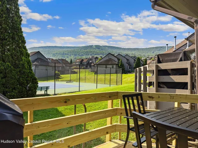 a view of a chairs and table on the balcony