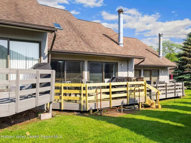 a front view of house with a garden and patio