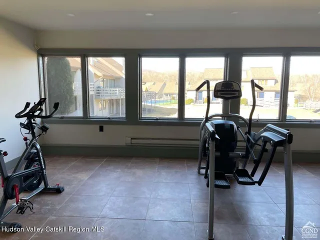 a room with gym equipment and a large window