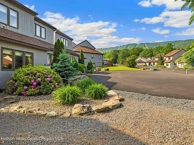 a front view of a house with a yard and outdoor seating