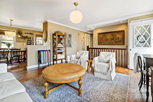 a living room with furniture a rug and a bookshelf