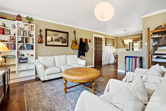 a living room with furniture and a book shelf