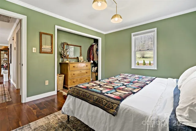 a bedroom with a bed and a dresser in it