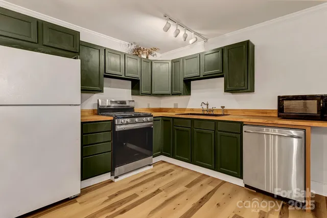 a kitchen with a refrigerator and a sink