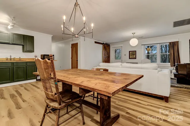 a view of a dining room with furniture and a chandelier