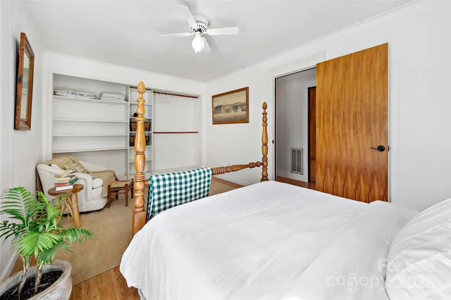 a bedroom with a bed and ceiling fan