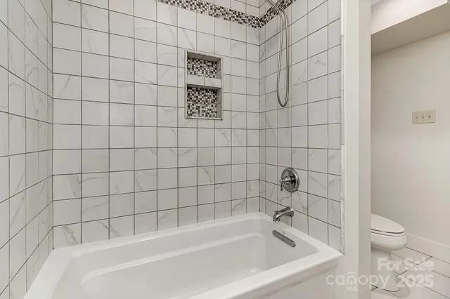 a bathroom with a bathtub and toilet