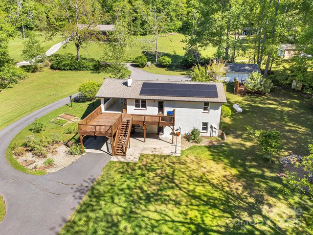 an aerial view of a house with swimming pool garden and patio