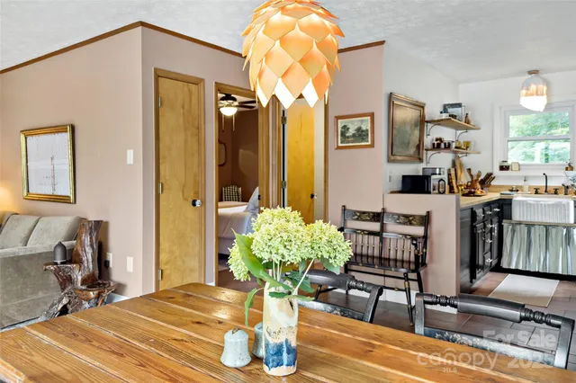 a view of a dining room with furniture and a chandelier
