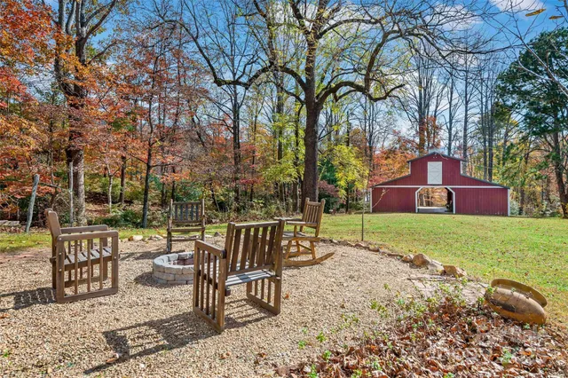 a view of a sitting area with trees in a backyard
