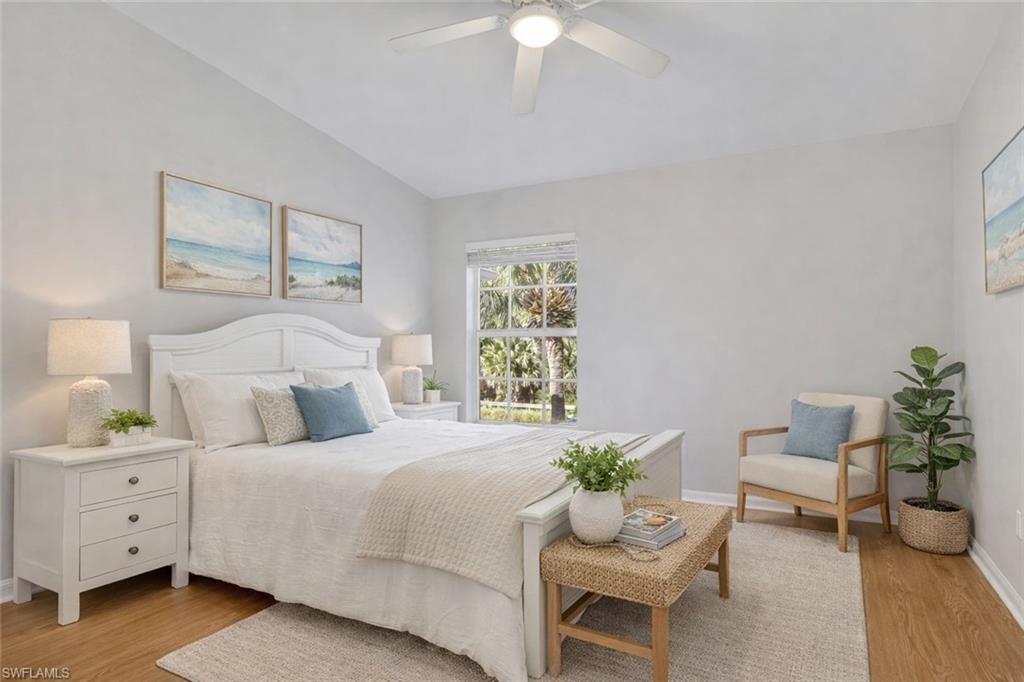 15918 Marcello Circle, Unit 239 Naples, FL 34110 - Photo 20 of 34 a bedroom with a bed and a table