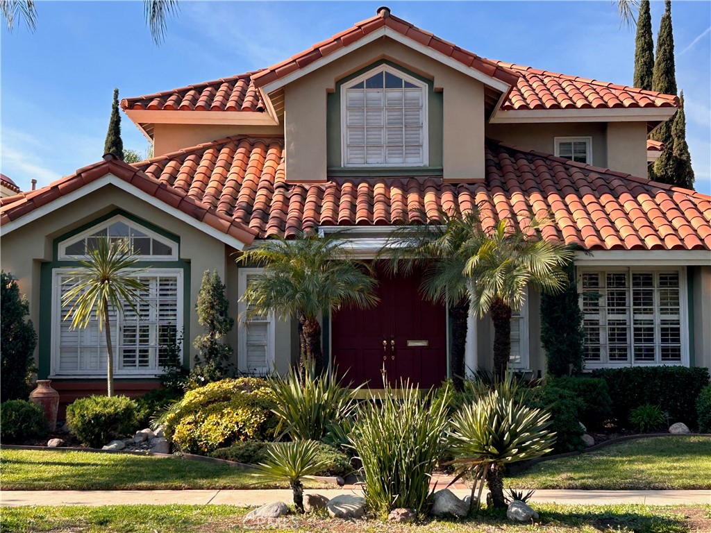 a view of a house with fountain and potted plants