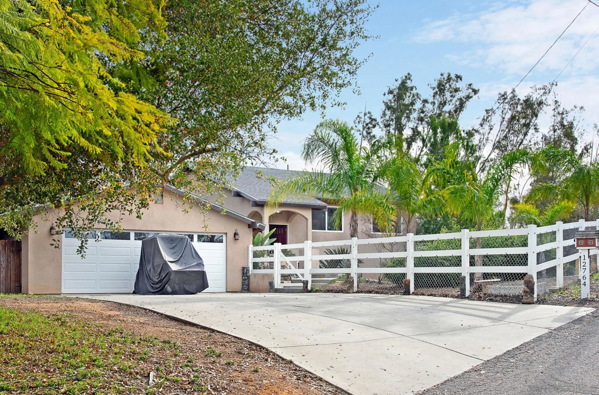 12764 Cumbres Road Valley Center, CA 92082 - Photo 3 of 22 a view of a house with a tree