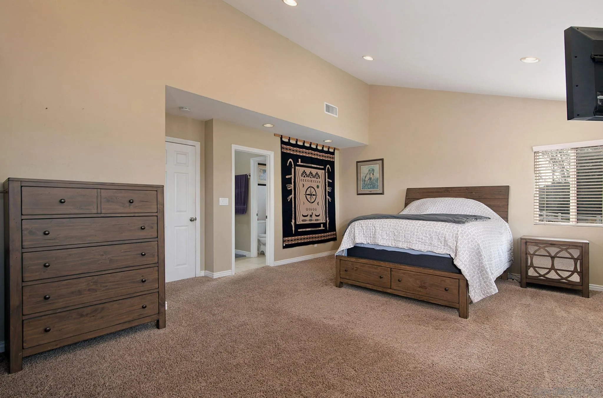 12764 Cumbres Road Valley Center, CA 92082 - Photo 7 of 22 a spacious bedroom with a bed and cabinet