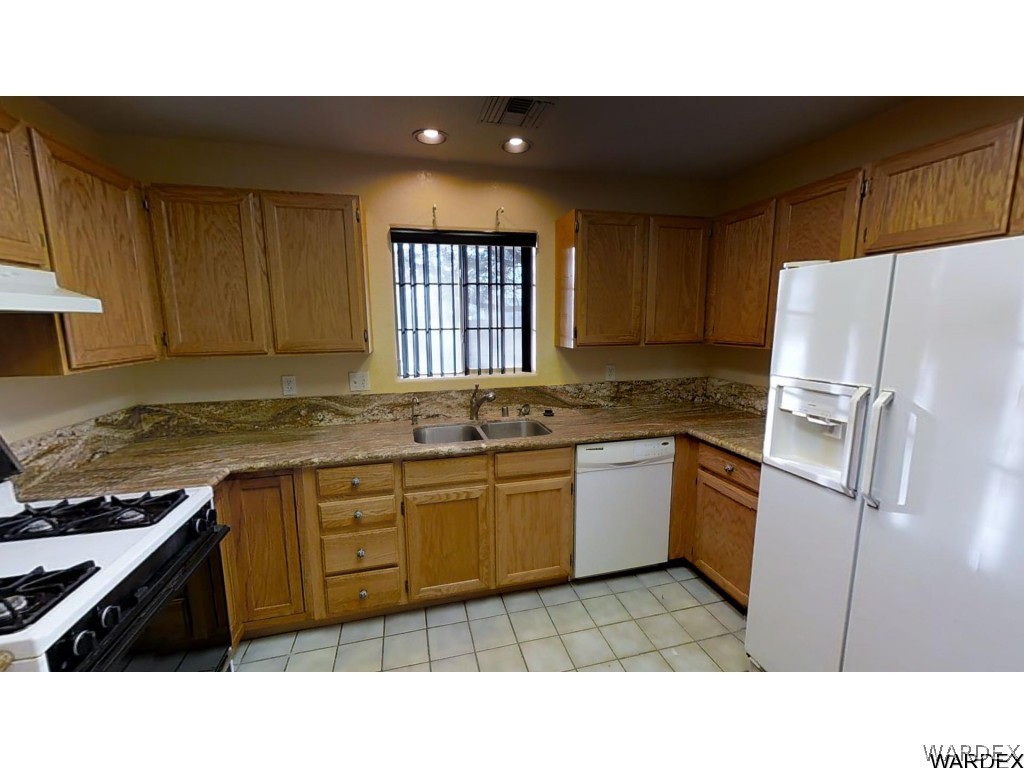 5850 Tableau Road Fort Mohave, AZ 86426 - Photo 9 of 20 a kitchen with a refrigerator and a sink