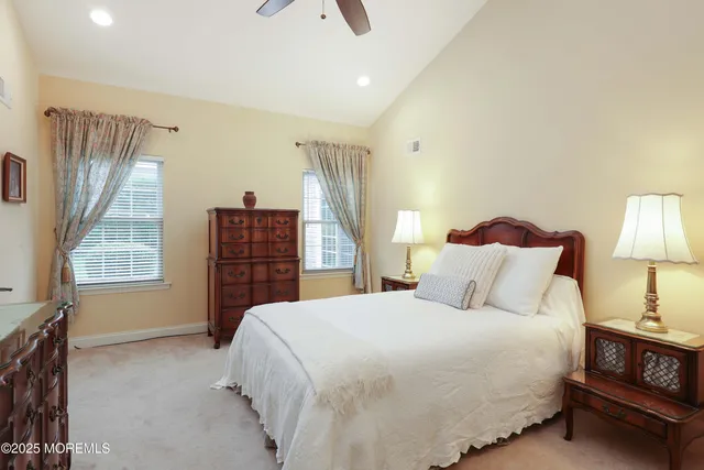 a bedroom with a bed dresser and a window