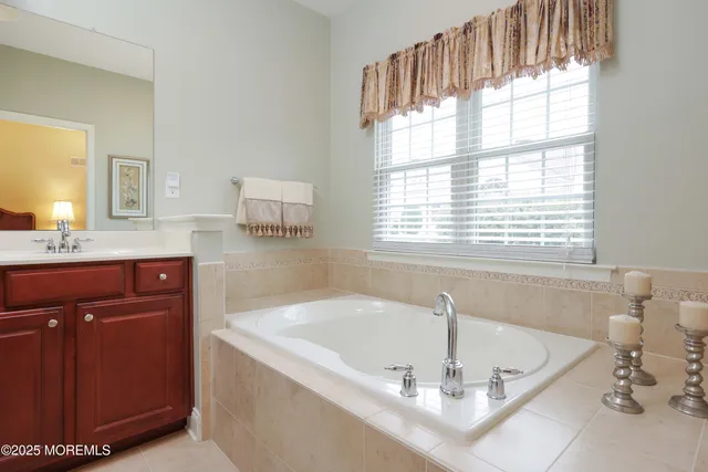 a bath tub sitting in a bathroom next to a window