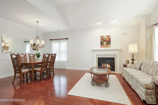 a living room with furniture a dining table and a fireplace