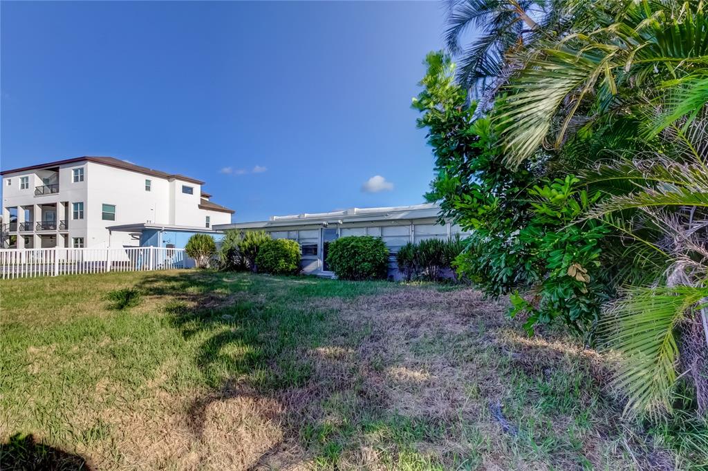 307 173rd Avenue North Redington Beach, FL 33708 - Photo 4 of 27 a view of a big yard with plants and large trees