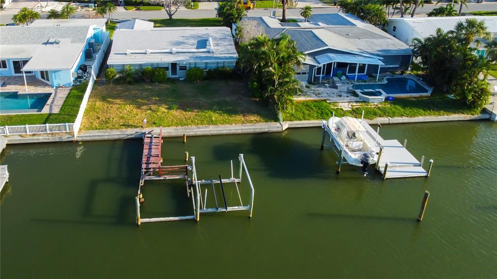307 173rd Avenue North Redington Beach, FL 33708 - Photo 6 of 27 an aerial view of a house with swimming pool a yard and lake view