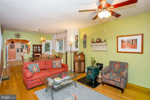 a dining room with furniture a chandelier and wooden floor