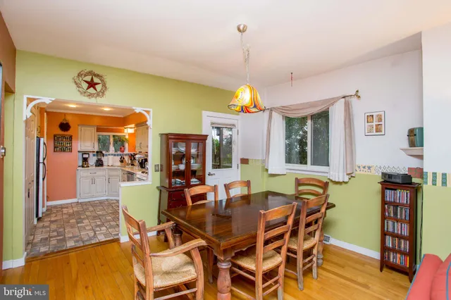 a dining room with furniture and wooden floor