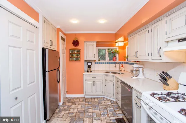 a kitchen with a sink and a refrigerator
