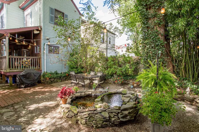 a view of a brick house with large windows and a small yard