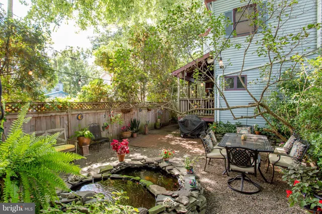 a living room with furniture fireplace and a large window
