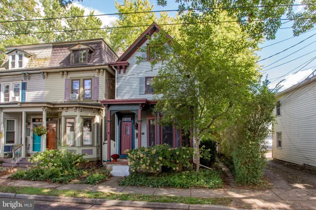 a living room with fireplace furniture and a flat screen tv