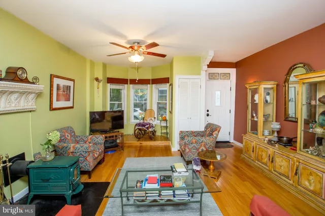 a view of a livingroom with furniture wooden floor and a chandelier